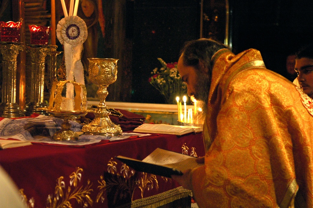 Orthodox Priest prepares the Sacrament of Holy Communion in a Church