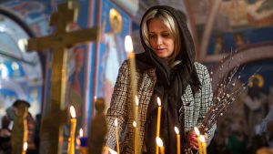 Orthodox woman lighting candles