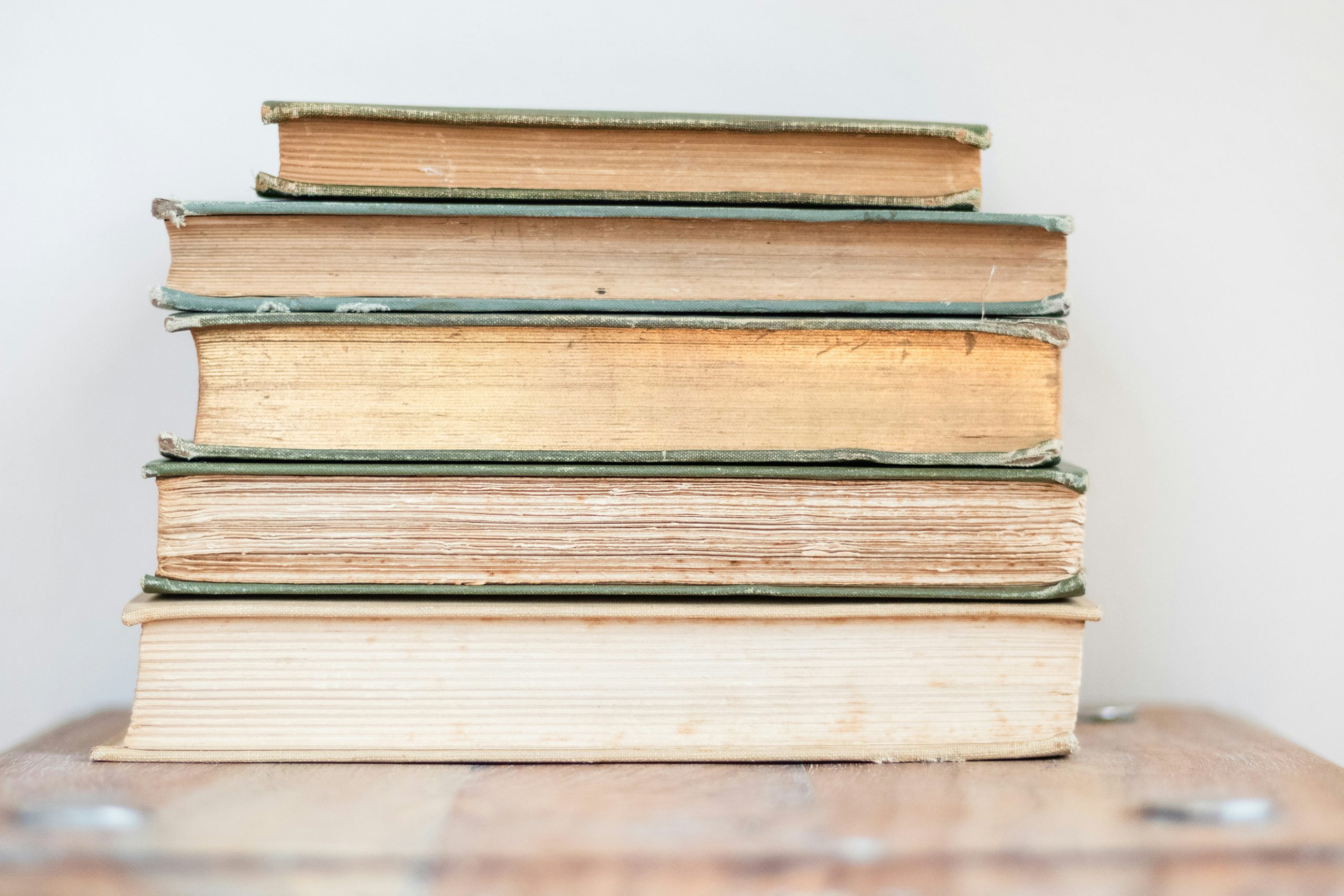 Pile of closed books showing the pages