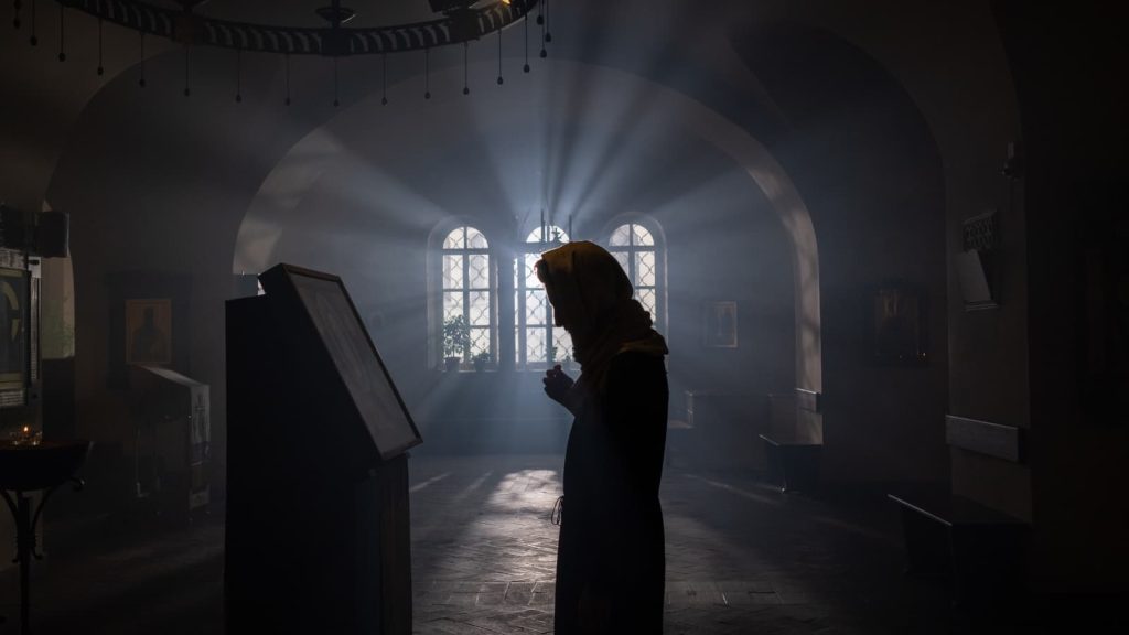 Orthodox woman finding inner peace through prayer.