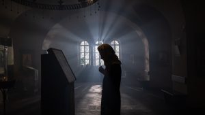 Orthodox woman finding inner peace through prayer.