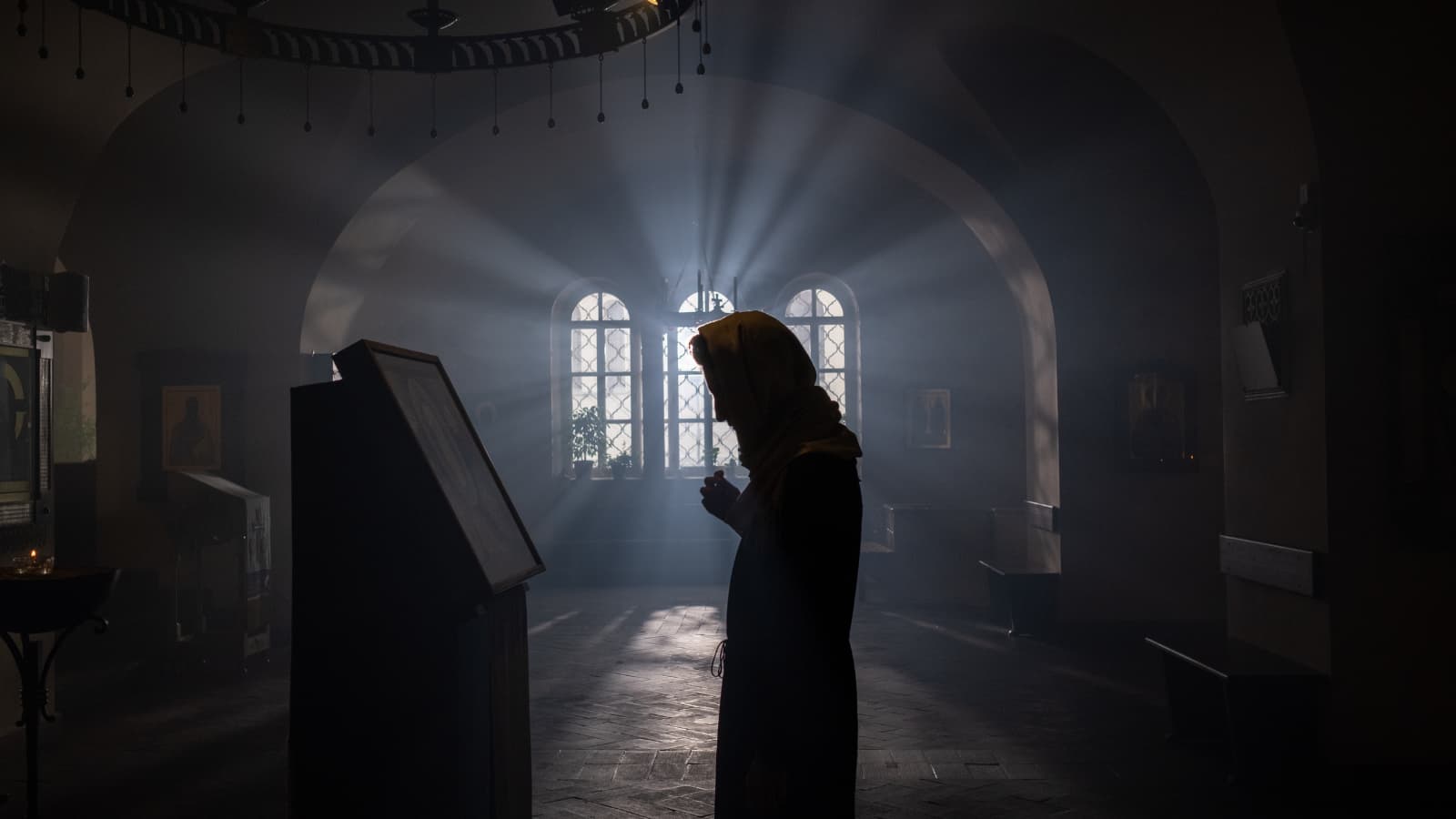 Orthodox woman finding inner peace through prayer.