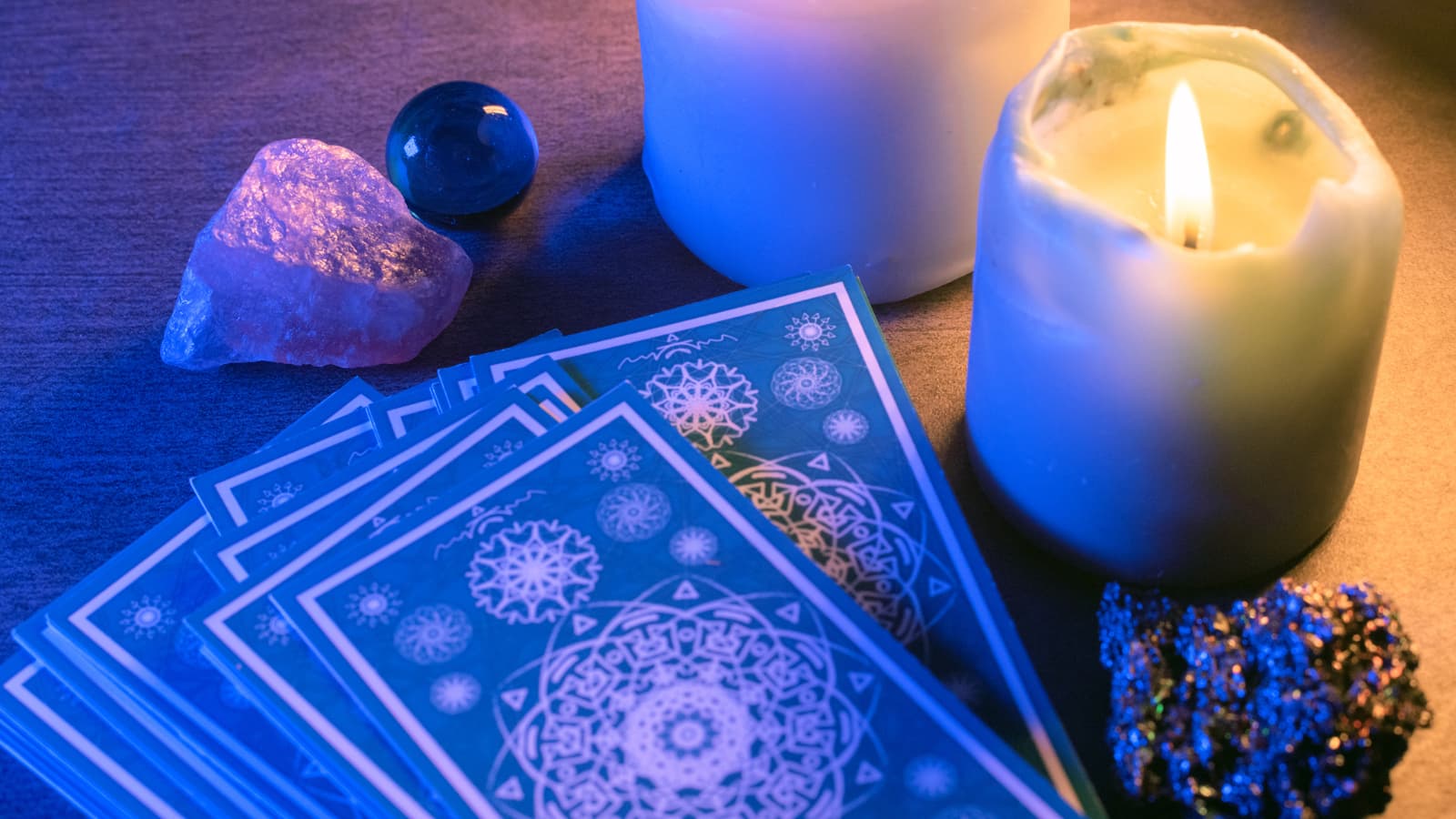 Tarot cards next to a lit candle