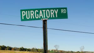 Road sign that says "Purgatory Road"